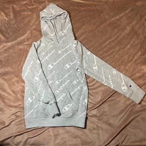 Kids gray Champion hoodie with an all-over script pattern, size small.